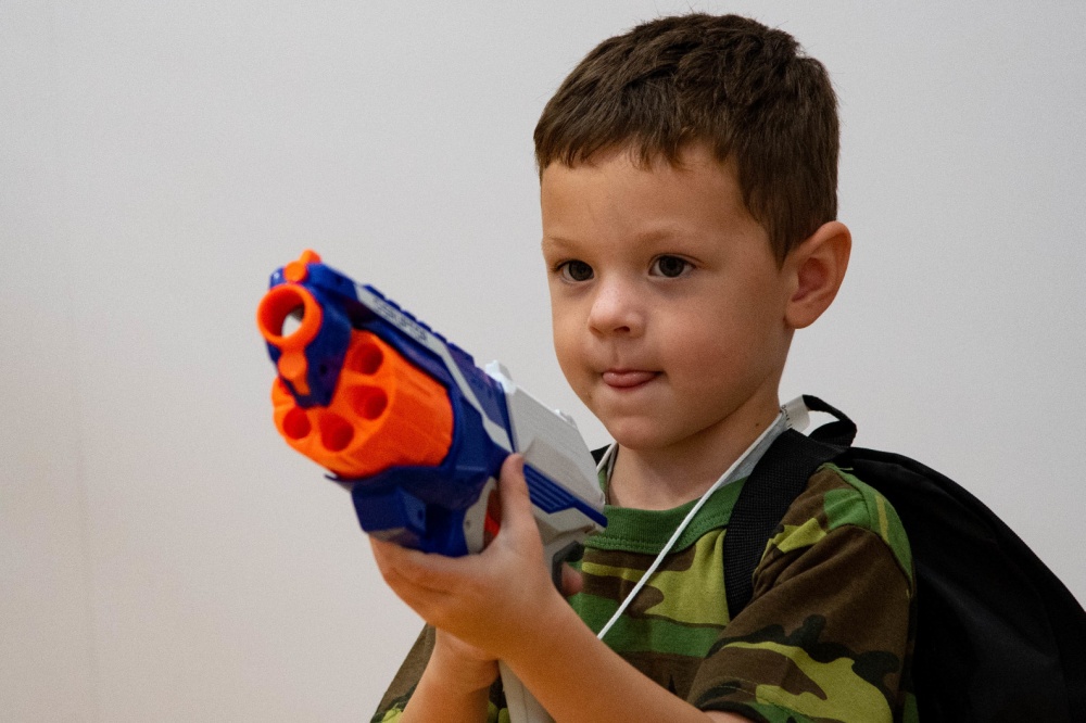 Boy Plays with Toy Gun